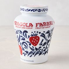 a white jar with blue and red designs on the lid that says fragol fibra