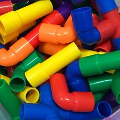 many different colored plastic pipes in a container