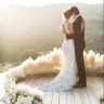 a bride and groom are standing on a dock