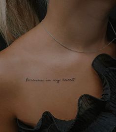 the back of a woman's neck with an inscription on it that reads, forever is my heart