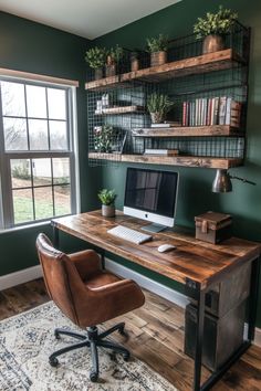 a desk with a computer on top of it in front of a window and shelves