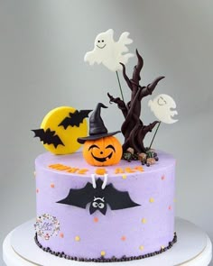 a cake decorated with halloween decorations and bats