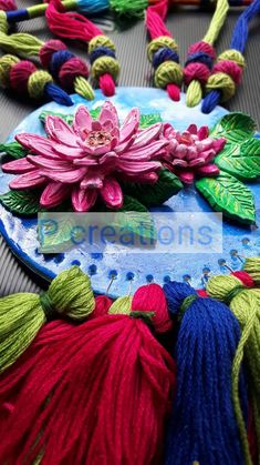 colorful flowers and tassels on a blue plate