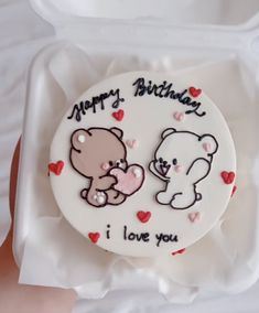 a birthday cake with two teddy bears on it in a white box that says happy birthday i love you