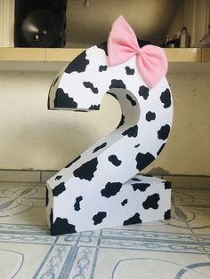 the number two is made out of cardboard with a pink bow