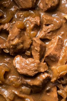 meat and vegetables are mixed together in a brown gravy sauce on a plate