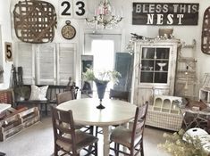 a room filled with furniture and lots of clocks on the wall above it's windows