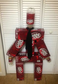 a cardboard man made out of soda cans