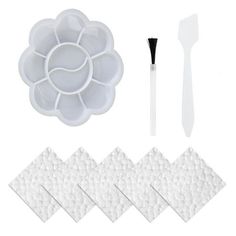 the cake decorating kit includes white fondant, spatulas and plastic flowers