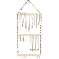 a wooden shelf with several necklaces hanging from it