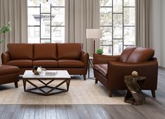 a living room filled with lots of furniture and large windows overlooking the cityscape