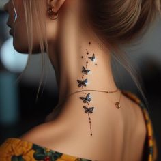 the back of a woman's neck is adorned with butterflies and stars on it