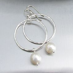 "White Freshwater Pearl Earrings~ These elegant sterling silver hoop earrings with a freshwater white pearl will look great for any occasion. Hammered and polished to a beautiful shine. Choose hoop size 1\" or 1.5\" Also available in 14k gold fill~ https://www.etsy.com/listing/199753367/white-pearl-hoop-earrings-small-gold?ref=shop_home_active_4 Also available with peacock pearls~ https://www.etsy.com/listing/269037112/peacock-pearl-earrings-freshwater-pearls?ref=listing-shop-header-0 Shop~bhttp Pearl White Sterling Silver Round Pearl Earrings, Pearl White Round Sterling Silver Pearl Earrings, Delicate Round Sterling Silver Pearl Earrings, Delicate Sterling Silver Round Pearl Earrings, Delicate Silver Hoop Earrings For Anniversary, White Sterling Silver Hoop Earrings, Classic Sterling Silver Hoop Earrings For Wedding, White Sterling Silver Hoop Earrings For Anniversary, White Sterling Silver Round Hoop Earrings