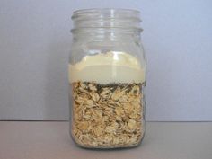 a glass jar filled with oatmeal and milk