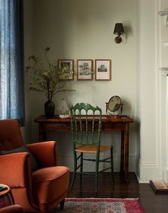 an orange chair sitting in front of a wooden table