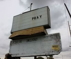 an old sign that says pray on top of it