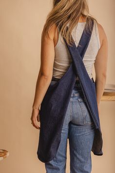 a woman with her back turned to the camera, wearing a blue scarf over her shoulder