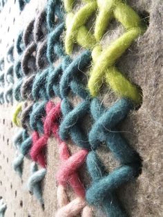 several different colored crocheted objects are on the wall