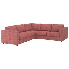 a red sectional couch sitting on top of a white floor