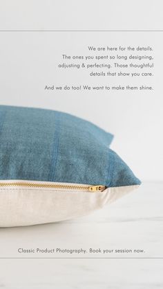 a blue pillow sitting on top of a wooden table next to a white wall with text