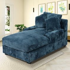 a large blue chaise lounger in a living room