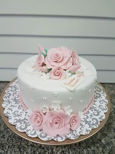 a white cake with pink flowers on top