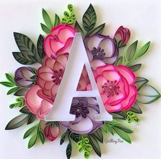 the letter a is surrounded by pink flowers and green leaves on a white background,