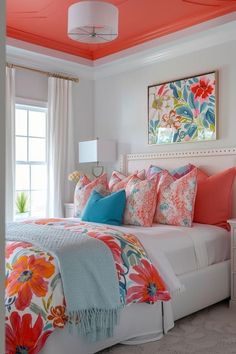 a white bed topped with lots of colorful pillows