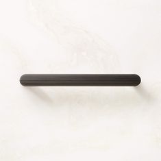 a black handle on a white wall