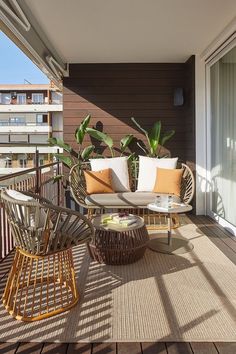 a balcony with wicker furniture and potted plants