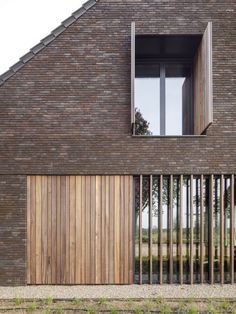 a brick building with wooden slats on the outside