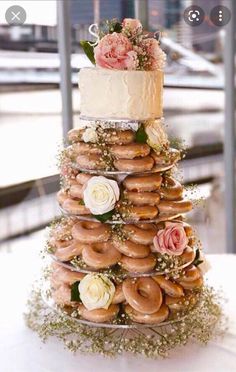 a wedding cake made out of doughnuts and flowers