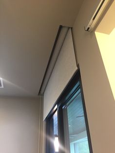 an air conditioner sitting on top of a window sill next to a wall