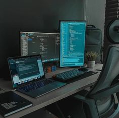 two laptops and a desktop computer on a desk