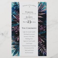 the ceremony program is displayed on a marble surface with blue and purple flowers in it