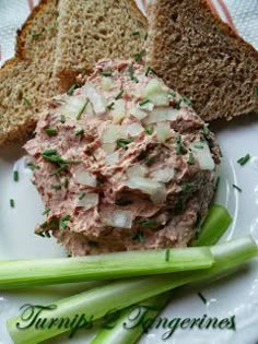 there is a sandwich on a plate with celery and bread next to it