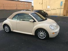 a small white car parked in a parking lot