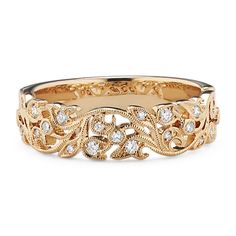 a gold ring with diamonds in the middle and an intricate design on it's side