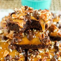 chocolate caramel brownies stacked on top of each other