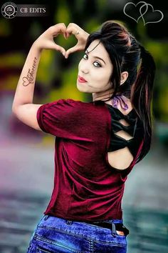 a woman making a heart with her hands