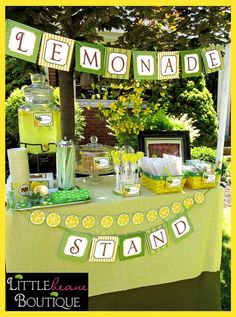 a lemonade stand is set up for a lemonade party with green and yellow decorations