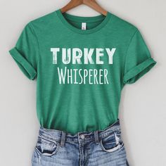 "Turkey Whisperer shirt - funny turkey shirt perfect for Thanksgiving, Turkey Shows, farmers and more! Size of text and image will vary depending on the size of the shirt. If you would like something different or would like specific information, please feel free to message me! Text color will be as indicated on color chart (i.e. shirts with white text will be printed with light color/image and shirts with black colored text shown on the chart will be printed with dark colored text/image).   Sizing: Unisex. All measurements are taken while the shirts are lying flat. Width is measured across the chest (under arm to underarm). Length is measured from shoulder to the bottom of the shirt. T-shirts Approximately (Brand: Bella Canvas; Shirts fit True to size): **Size up 1-3 sizes for oversized lo Turkey Lover, Liberal Shirt, Chef Shirt, Squirrel Gift, Chef Shirts, Squirrel Funny, Funny Thanksgiving Shirts, Farmer Shirt, Turkey Shirts