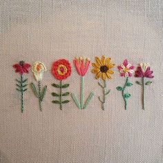 embroidered flowers are arranged in the shape of letters