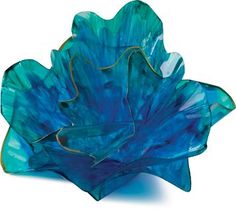 a blue flower shaped bowl sitting on top of a white table