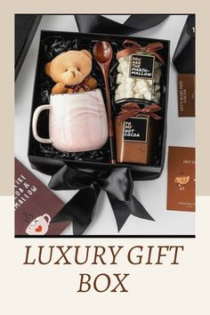 the luxury gift box is filled with chocolates, marshmallows and a teddy bear