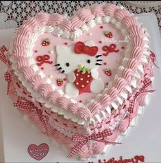 a heart shaped cake with hello kitty on it