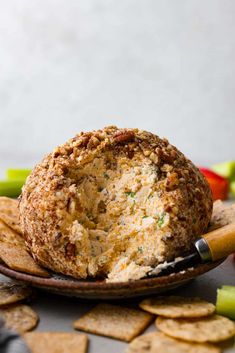 a cheese ball on a plate with crackers