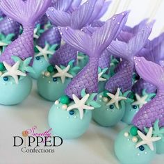 purple and green cake pops with mermaid decorations