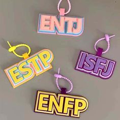 four different types of magnets hanging on a gray wall with the words entd