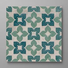 a green and white wall hanging on the side of a gray wall with an abstract design